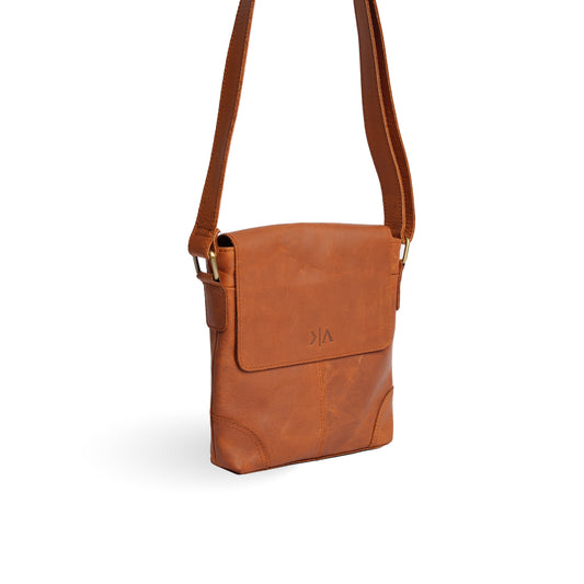 Vintage brown leather crossbody bag shown at an angle, revealing the side gusset